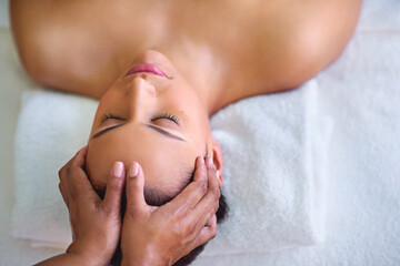 Here, beauty is in the hands of the beholder. a young woman receiving a head massage at a spa.