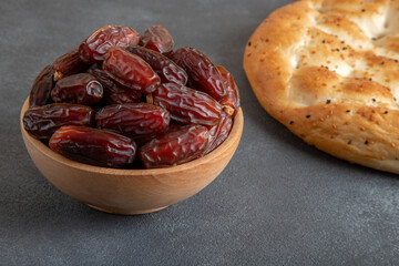 Date fruits,traditional ramadan pita on black background
