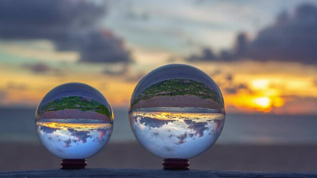 time lapse view of colorful nature at sunset inside crystal balls..beautiful cloud in sky over sea in a crystal ball on the beach. .Nature High quality footage in nature and travel concept..