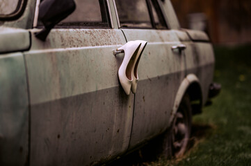 The bride's white wedding shoes on an old car. Princess's shoes. 