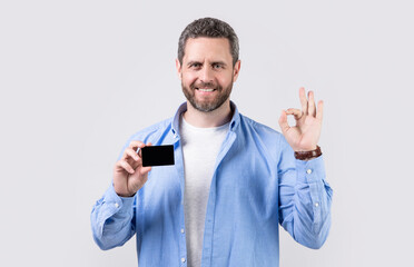 photo of positive man hold business debit. man show business debit isolated on studio