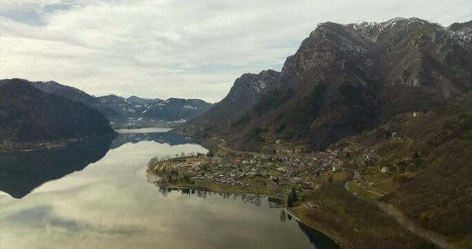 Aerial View Of Anfo Town In Lombardia Beside Calm Reflective Lake Idro 
