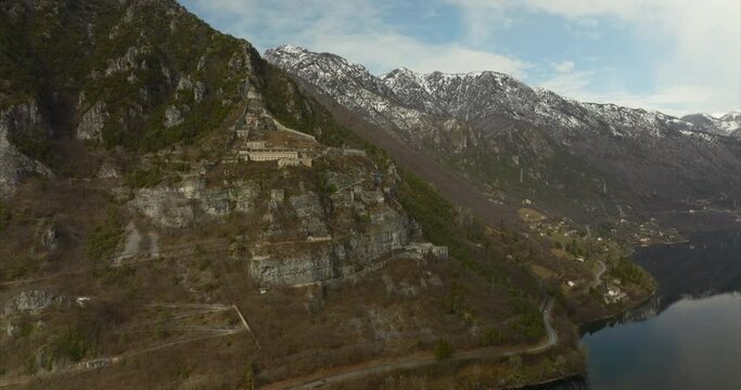 Aerial View Of Historic Military Fortification Rocca d'Anfo Beside  Lake Idro. Circle Dolly Shot