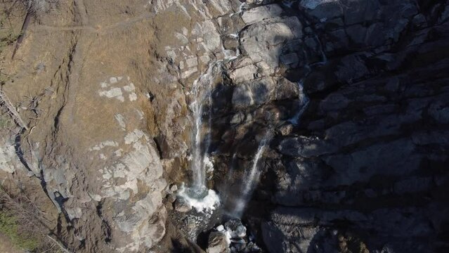 Aerial descent to Arpenaz waterfall in Sallanches, French Alps.