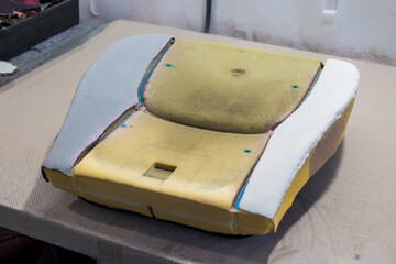  A photo of the foam repair process on the padding of a car seat