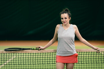 Tennis woman player portrait with racket and ball at court.