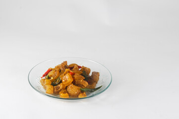 stir-fried kikil or knuckle served on a small plate isolated on a white background