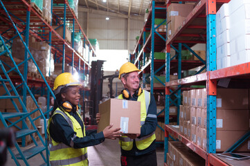 Foreman with employees in warehouse Help each other lift the product boxes to fill them all in the...