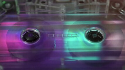 Spinning cassette tape in the cassette player, close-up, 80s, 90s style music concept, neon light colors. Synthwave, retrowave style. - Powered by Adobe