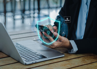 Cybersecurity system of global technology network on smart device, privacy digital data protection concepts. Safety shield and padlock icons appear while business person using mobile phone in hands.