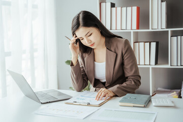 Asian businesswoman in formal suit in office happy and cheerful during using smartphone and working