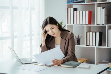 Asian businesswoman in formal suit in office happy and cheerful during using smartphone and working