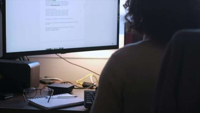 Productive Workday: Unrecognizable Caucasian Man with Long Curly Hair and Glasses Working from Home