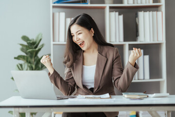 Asian businesswoman in formal suit in office happy and cheerful during using smartphone and working