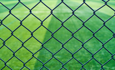 Fototapeta premium Barbed wire fence outside a football field