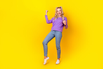 Fototapeta na wymiar Full body photo of attractive young woman raise fists luck win lottery dressed stylish violet outfit isolated on yellow color background