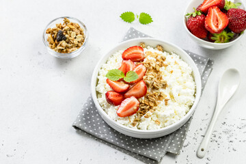 Strawberry granola cottage cheese bowl. Top view, copy space, flat lay.