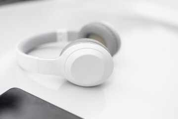 white wireless headphones on a white background using Bluetooth headphones to connect.