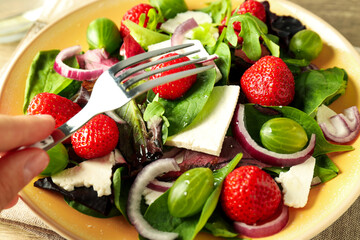 Concept of tasty salad, salad with strawberry, close up