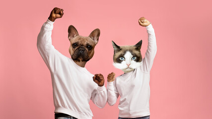 Cheery black couple with animal faces celebrating success on pink