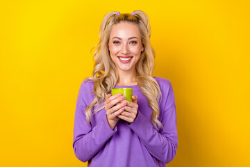 Photo of cheerful funny woman wear violet shirt enjoying tasty beverage isolated yellow color background - obrazy, fototapety, plakaty