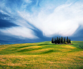 Fototapeta premium Scenic landscape with hills against clouds in Val d'Orcia, Tuscany, Italy. Wonderful places.