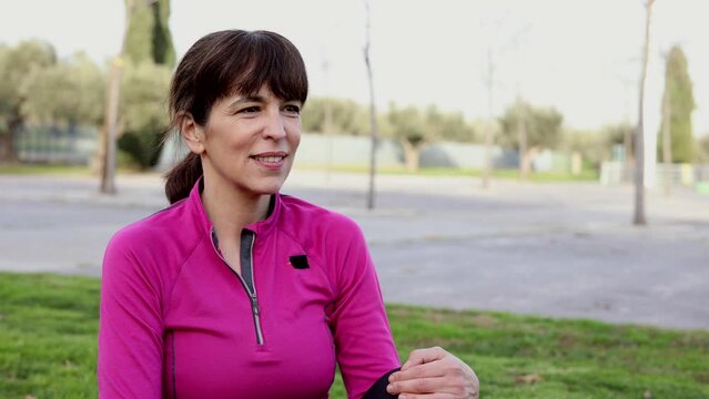 relaxed mature woman in the park in sportswear