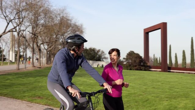 Fitness is an important part of your marriage. mature couple exercise together in the park, bike and run.