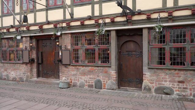 A tavern or tavern in an old-fashioned historical house of interest on the cobbled street of the old Danish town of Odense