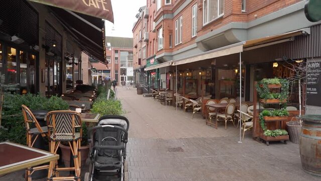Low old-fashioned red brick houses on cobbled cozy streets in the center of the old Danish city of Odense.