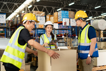 Asian warehouse workers team holding digital tablet talk about Inventory check and product delivery in retail warehouse full of shelves with goods. teamwork at warehouse storage department.