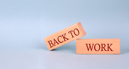 BACK TO WORK text on the wooden block, blue background