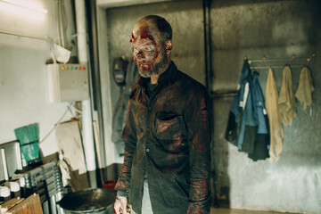 Fototapeta na wymiar Zombie male makeup for halloween concept. Make up skin and blood face