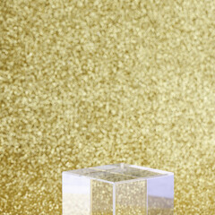 transparent podium for product display on yellow glittering background. pedestal, stage for product. copy space. selective focus square