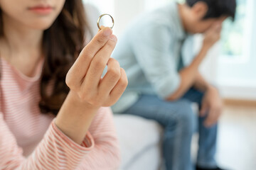 Divorce. Woman remove married ring. Couples desperate and disappointed after marriage. Husband wife sad, upset and frustrated after quarrels conflict. distrust, love problems, betrayals, family, lover - obrazy, fototapety, plakaty