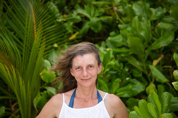woman portrait and lush tropical greenery