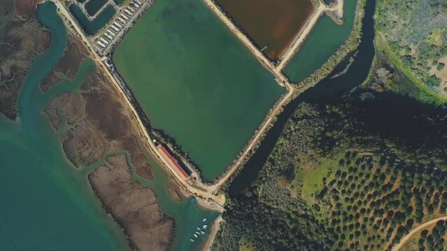 Topdown perspective looking at disused discolored fish farm pools 