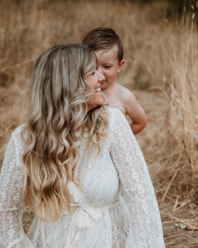Happy mother and son together in field outside