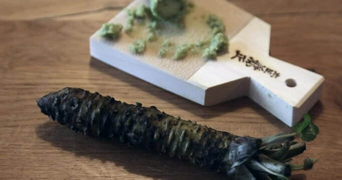 Fresh wasabi rhizome grated on a Japanese sharkskin grater