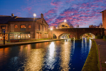 Sunset and brick buildings alongside a water canal in the central Birmingham, England