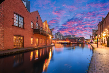 Sunset and brick buildings alongside a water canal in the central Birmingham, England