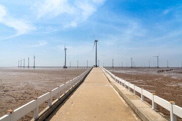 Naklejka premium Seascape with Turbine Green Energy Electricity, Windmill for electric power production, wind turbines generating electricity on the sea at Bac Lieu province, Vietnam