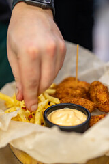 chef cooking Chicken Nuggets with French Fries and sauce on kitchen