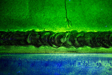 Crack steel butt weld carbon background green contrast magnetic filed fluorescent test