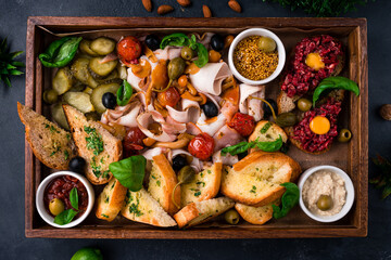 Russian snack for vodka lard, pork, cucumbers, tomatoes, mushrooms, olives, capers, French mustard, horseradish, beef tartar, basil.