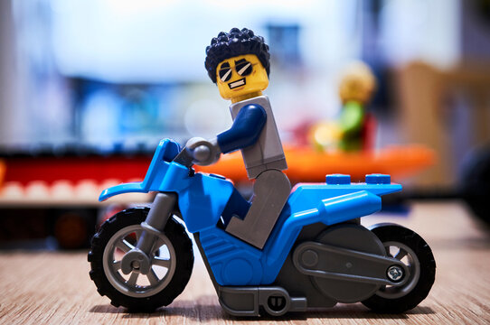 Lego man figurine sitting on a motorcycle 