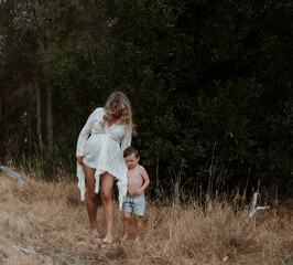 Pregnant Mother walking with son outside