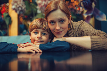 Mother and child sitting in caffe portrait