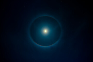 Bright moon with halo on night sky
