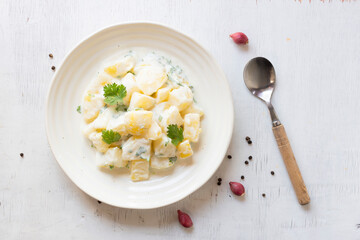 Healthy food potato salad creamy mayonnaise in bowl on wood table top view copy space.